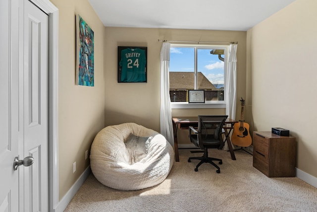 carpeted office featuring baseboards
