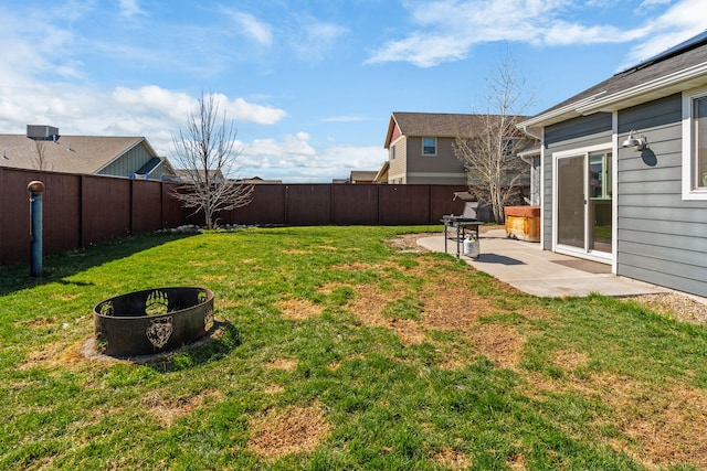 view of yard with a fenced backyard, a fire pit, and a patio area