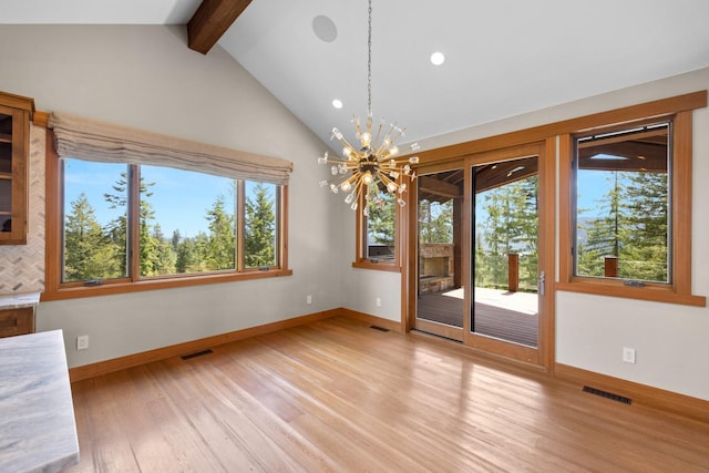 unfurnished dining area featuring a wealth of natural light, a notable chandelier, and visible vents