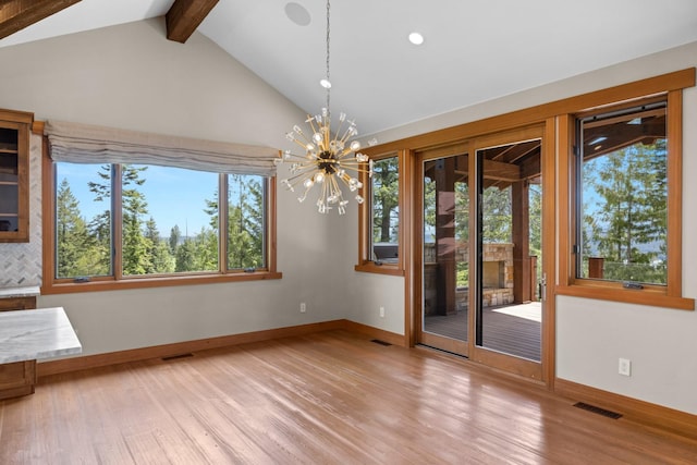 unfurnished dining area with visible vents, wood finished floors, and a healthy amount of sunlight