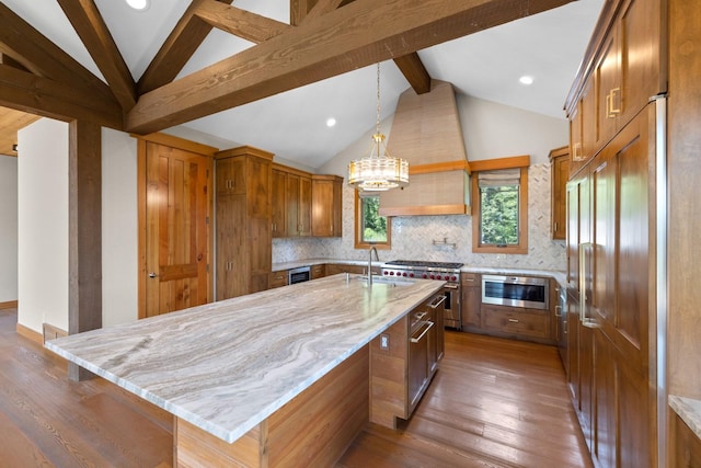 kitchen with light stone countertops, high end stainless steel range, a sink, vaulted ceiling with beams, and backsplash