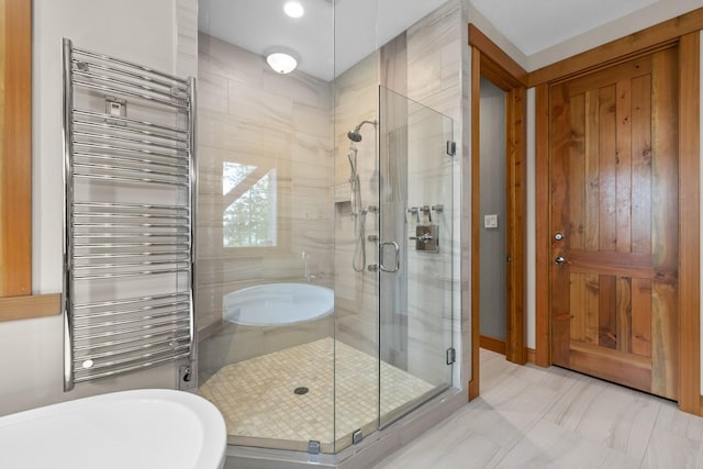bathroom with radiator and a shower stall