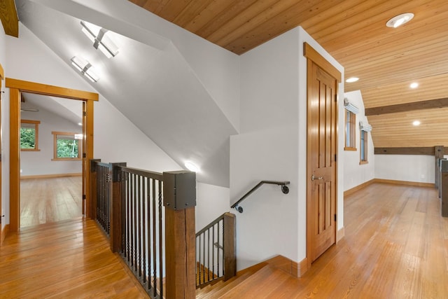 corridor featuring wooden ceiling, lofted ceiling, an upstairs landing, and hardwood / wood-style flooring