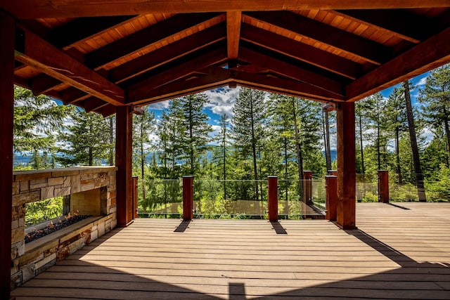 deck featuring an outdoor stone fireplace