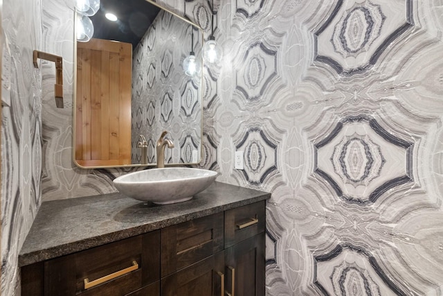bathroom featuring vanity and backsplash