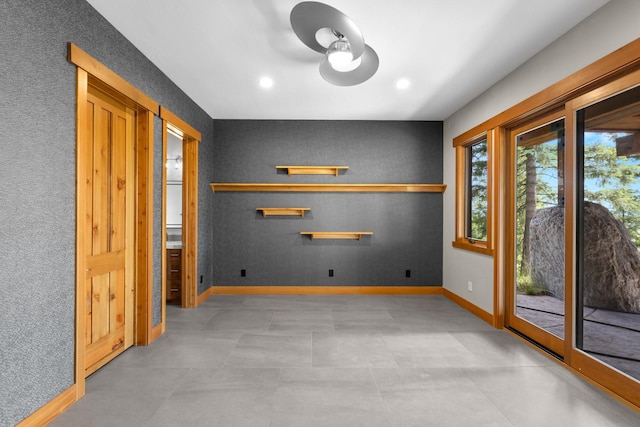 spare room with baseboards, a ceiling fan, and recessed lighting
