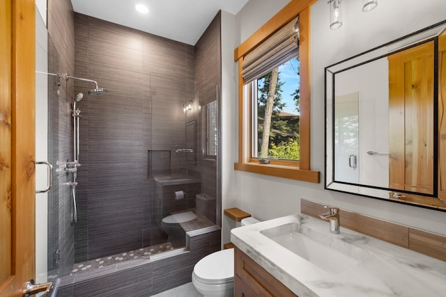 full bathroom featuring vanity, recessed lighting, toilet, and a shower stall