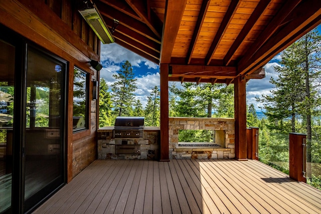 wooden terrace with grilling area and exterior kitchen