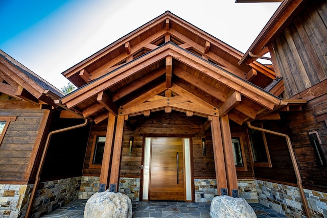 view of exterior entry featuring stone siding
