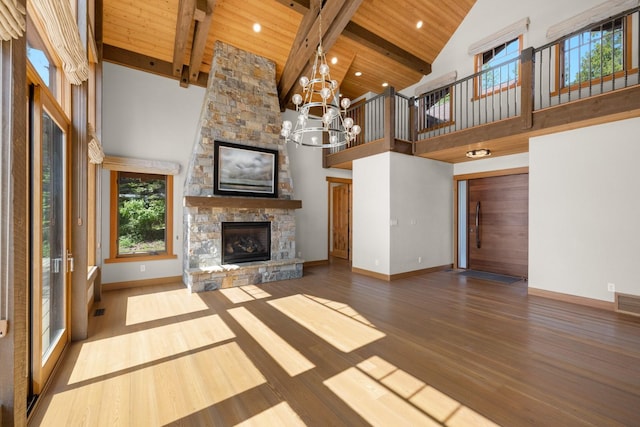 unfurnished living room featuring wooden ceiling, baseboards, a fireplace, and high vaulted ceiling