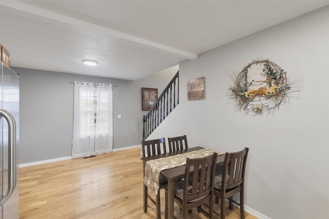 208 40th Ave NE, Great Falls, MT 59404 - dining room with light wood-type flooring, baseboards, visible vents, and stairway