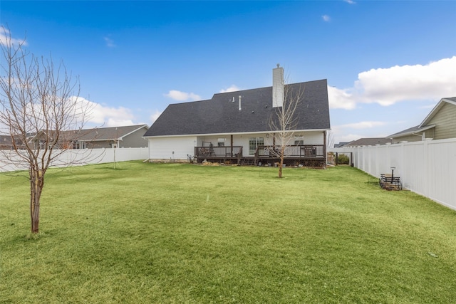 208 40th Ave NE, Great Falls, MT 59404 - rear view of property featuring a lawn, a fenced backyard, a wooden deck, and a chimney