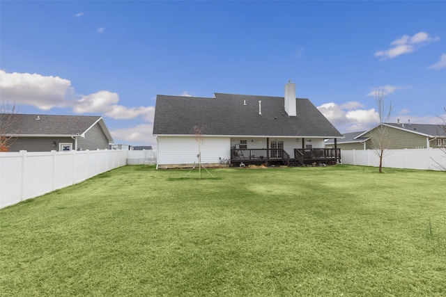 208 40th Ave NE, Great Falls, MT 59404 - back of house featuring a fenced backyard, a chimney, a lawn, and a deck