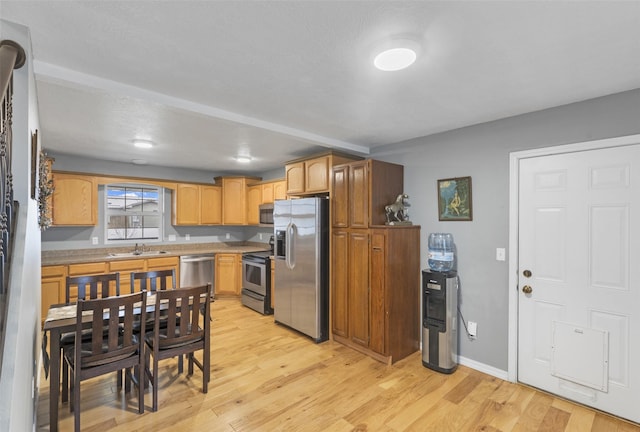208 40th Ave NE, Great Falls, MT 59404 - kitchen featuring light countertops, appliances with stainless steel finishes, a sink, and light wood-style flooring