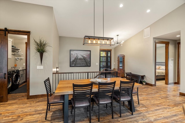14 Marina Crest Ln, Whitefish, MT 59937 - dining room featuring wood finished floors, washer and dryer, baseboards, recessed lighting, and vaulted ceiling