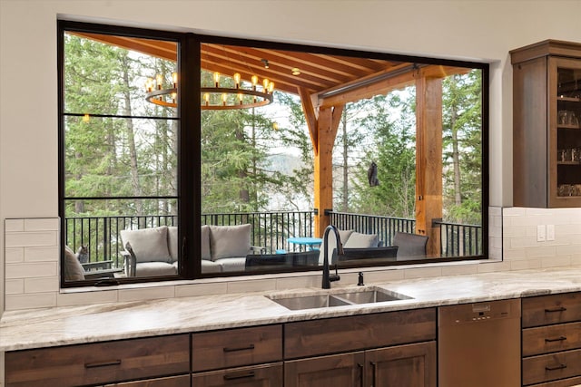 14 Marina Crest Ln, Whitefish, MT 59937 - kitchen featuring light stone countertops, a sink, dishwasher, backsplash, and glass insert cabinets