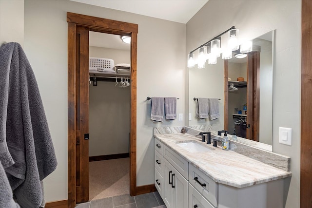 14 Marina Crest Ln, Whitefish, MT 59937 - bathroom with tile patterned floors, a spacious closet, baseboards, and vanity