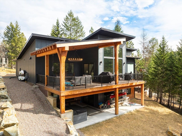14 Marina Crest Ln, Whitefish, MT 59937 - back of property featuring a wooden deck and a patio area