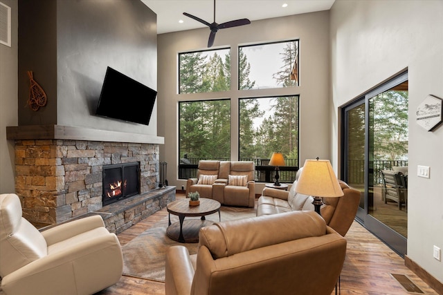 14 Marina Crest Ln, Whitefish, MT 59937 - living area with a fireplace, a ceiling fan, recessed lighting, wood finished floors, and a towering ceiling