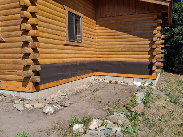view of side of home featuring log exterior