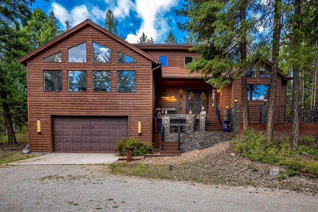 view of front of property with covered porch, driveway, and a garage