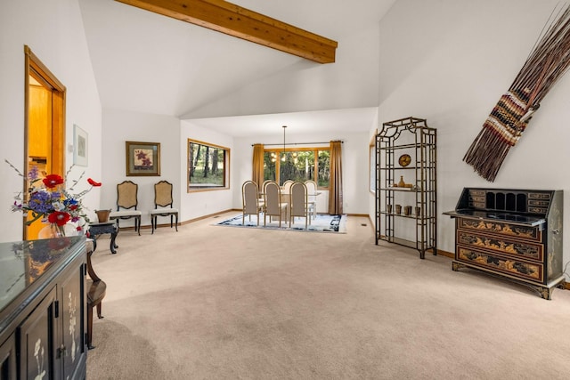 sitting room with beamed ceiling, baseboards, light carpet, and high vaulted ceiling