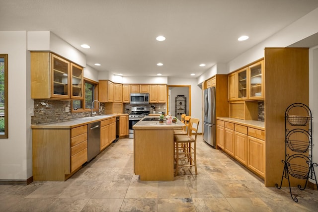 145 Little Mountain Ln, Whitefish, MT 59937 - kitchen featuring appliances with stainless steel finishes, a breakfast bar, a center island, light countertops, and recessed lighting