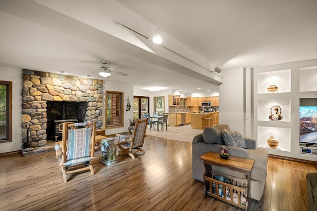 145 Little Mountain Ln, Whitefish, MT 59937 - living area featuring wood finished floors, ceiling fan, and a stone fireplace