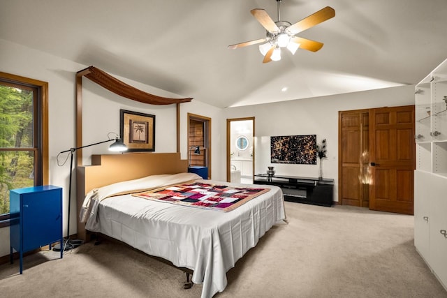 bedroom featuring a ceiling fan, light carpet, and vaulted ceiling
