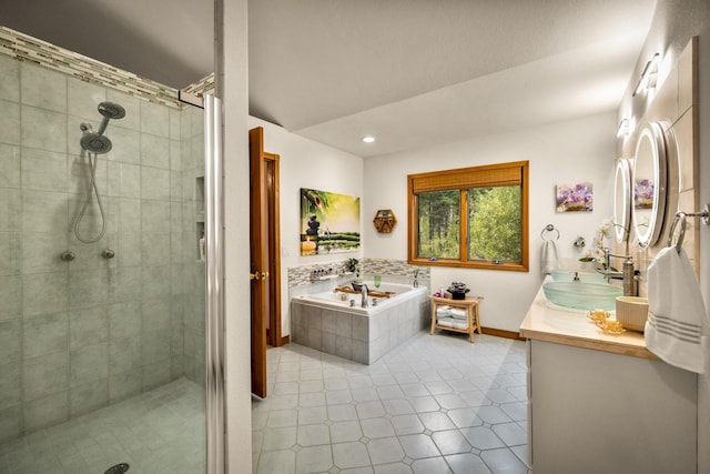 bathroom featuring double vanity, a sink, a bath, and a stall shower