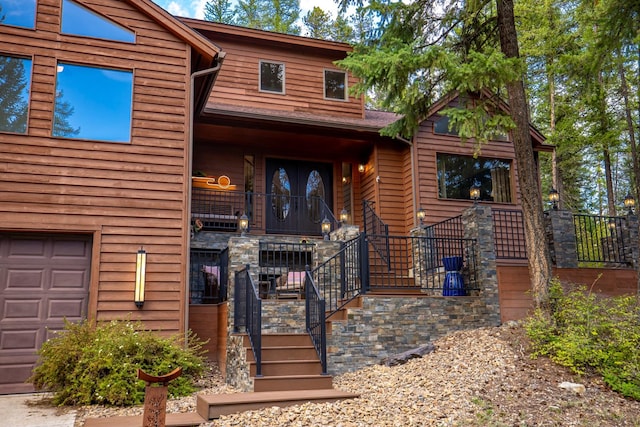 view of front facade featuring a garage and stairway