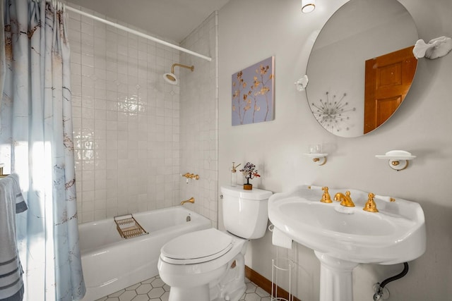 bathroom with tile patterned flooring, shower / tub combo, baseboards, and toilet