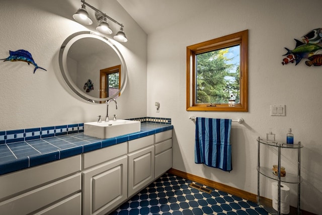 bathroom with vanity and baseboards
