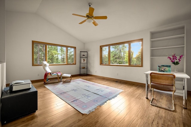 office featuring ceiling fan, vaulted ceiling, wood finished floors, and a wealth of natural light