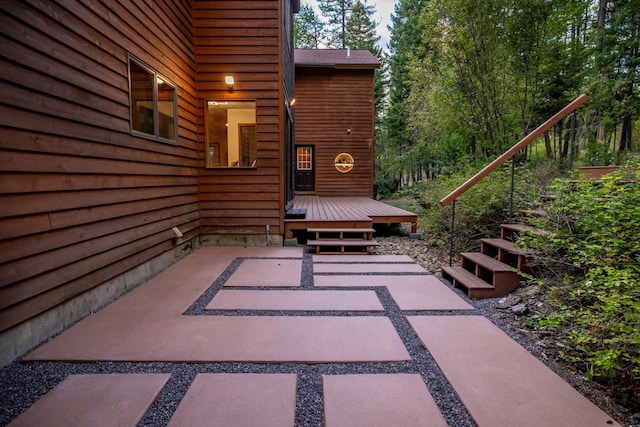 view of patio with stairway and a wooden deck