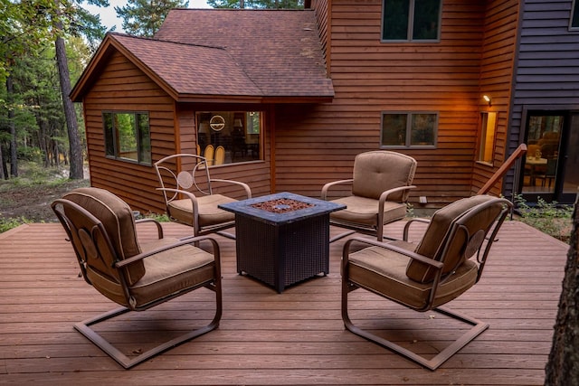 wooden terrace with an outdoor fire pit