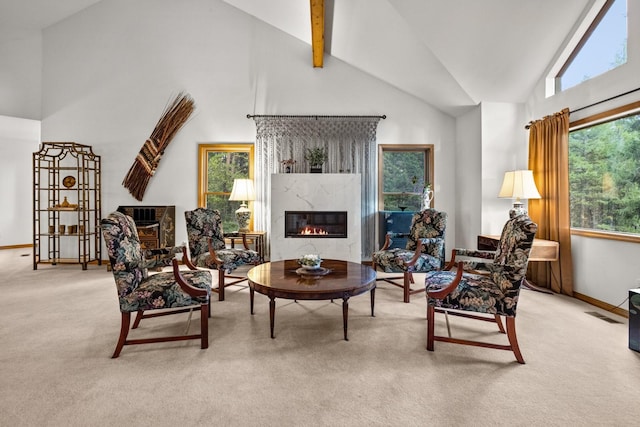 carpeted living room with high vaulted ceiling, baseboards, beam ceiling, and a premium fireplace