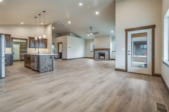 kitchen featuring ceiling fan, light countertops, high vaulted ceiling, stainless steel appliances, and visible vents