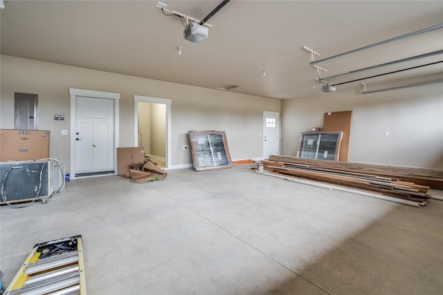 garage featuring a garage door opener and electric panel