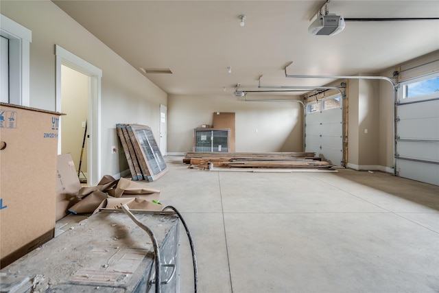 garage featuring baseboards and a garage door opener