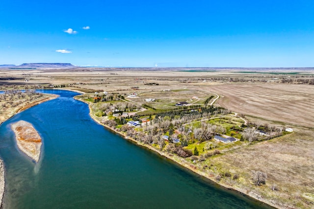 drone / aerial view featuring a water and mountain view