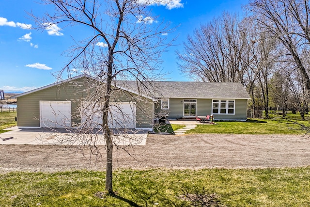 view of front of property featuring a garage, a patio, concrete driveway, and a front lawn