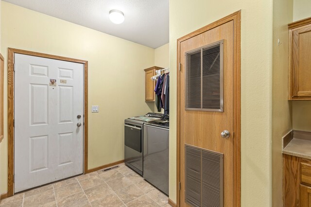 laundry area with cabinet space, independent washer and dryer, baseboards, and visible vents