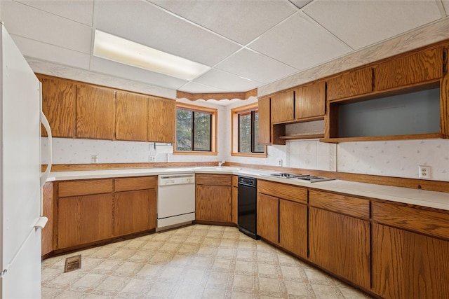 kitchen with light countertops, light floors, brown cabinets, and white appliances