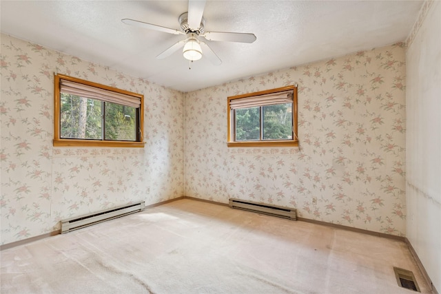 empty room with visible vents, a baseboard radiator, ceiling fan, and light colored carpet