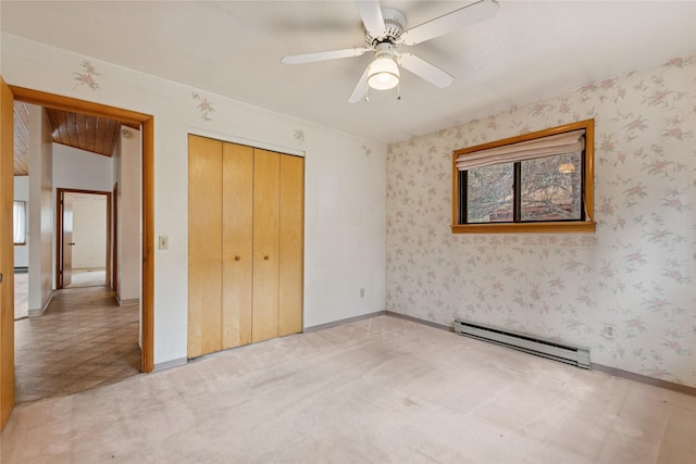 unfurnished bedroom featuring a closet, a baseboard radiator, a ceiling fan, and light carpet