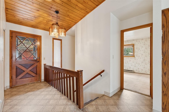 entrance foyer with an inviting chandelier, baseboards, light floors, a baseboard heating unit, and wooden ceiling