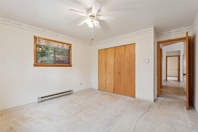 535 Reservoir Rd, Whitefish, MT 59937 - unfurnished bedroom with light carpet, baseboards, a baseboard heating unit, ornamental molding, and a closet
