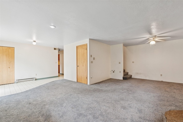 spare room with carpet floors, stairs, ceiling fan, and baseboard heating