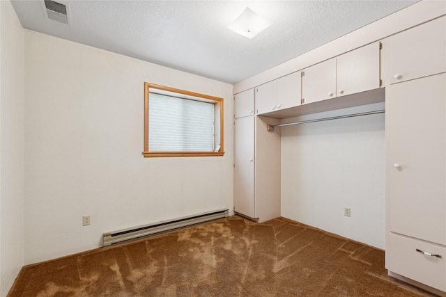 535 Reservoir Rd, Whitefish, MT 59937 - unfurnished bedroom featuring carpet floors, a baseboard heating unit, visible vents, and a closet